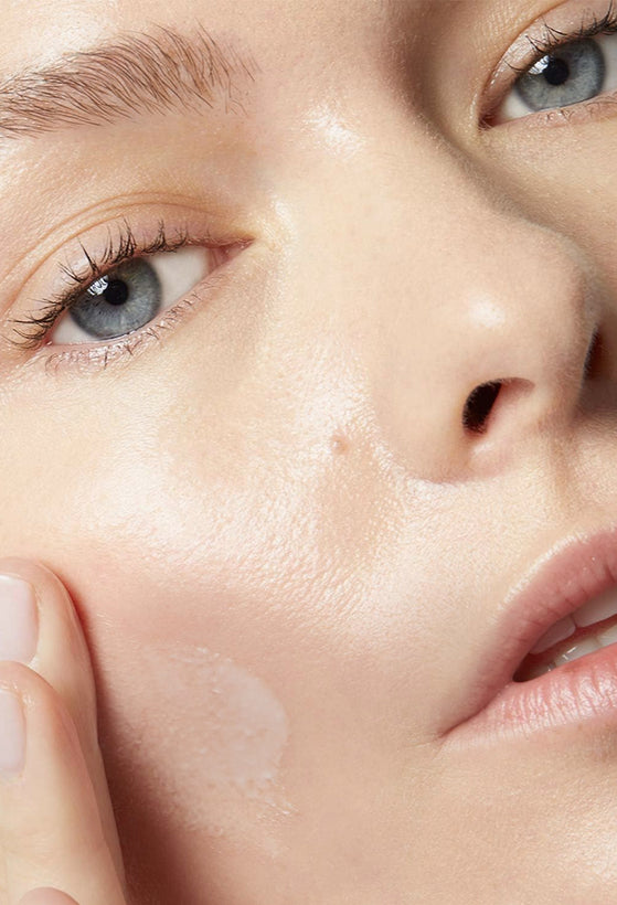 Women applying cream on her face Anne Semonin