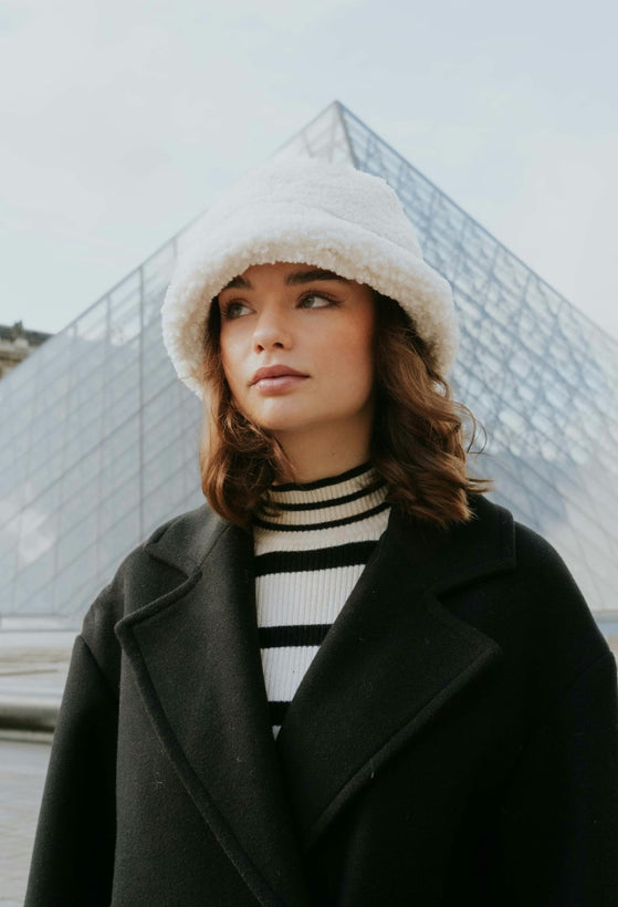 Women face with a bonnet standing close to the Louvre